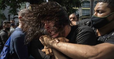 Plainclothes police detain an anti-government protester during a demonstration over high prices, food shortages and power outages, while some people also called for a change in the government, in Havana, Cuba, July 11, 2021. (AP Photo)
