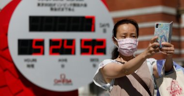 A woman takes a selfie in front of a Tokyo 2020 Olympic Games countdown clock in Tokyo, Japan, July 16, 2021. (Reuters Photo)
