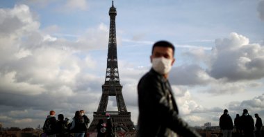 A man wearing a protective face mask walks at Trocadero square near the Eiffel Tower in Paris amid the coronavirus disease outbreak in France, January 22, 2021. (Reuters Photo)