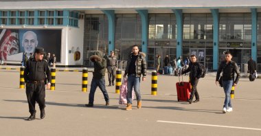A group of young men leave the airport with police accompaniment in Kabul, Afghanistan, Feb. 23, 2017. (Photo by Getty Images)