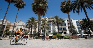 A man rides a bike at a pedestrian area in Sitges town, south of Barcelona, Spain, July 15, 2021. (Reuters Photo)