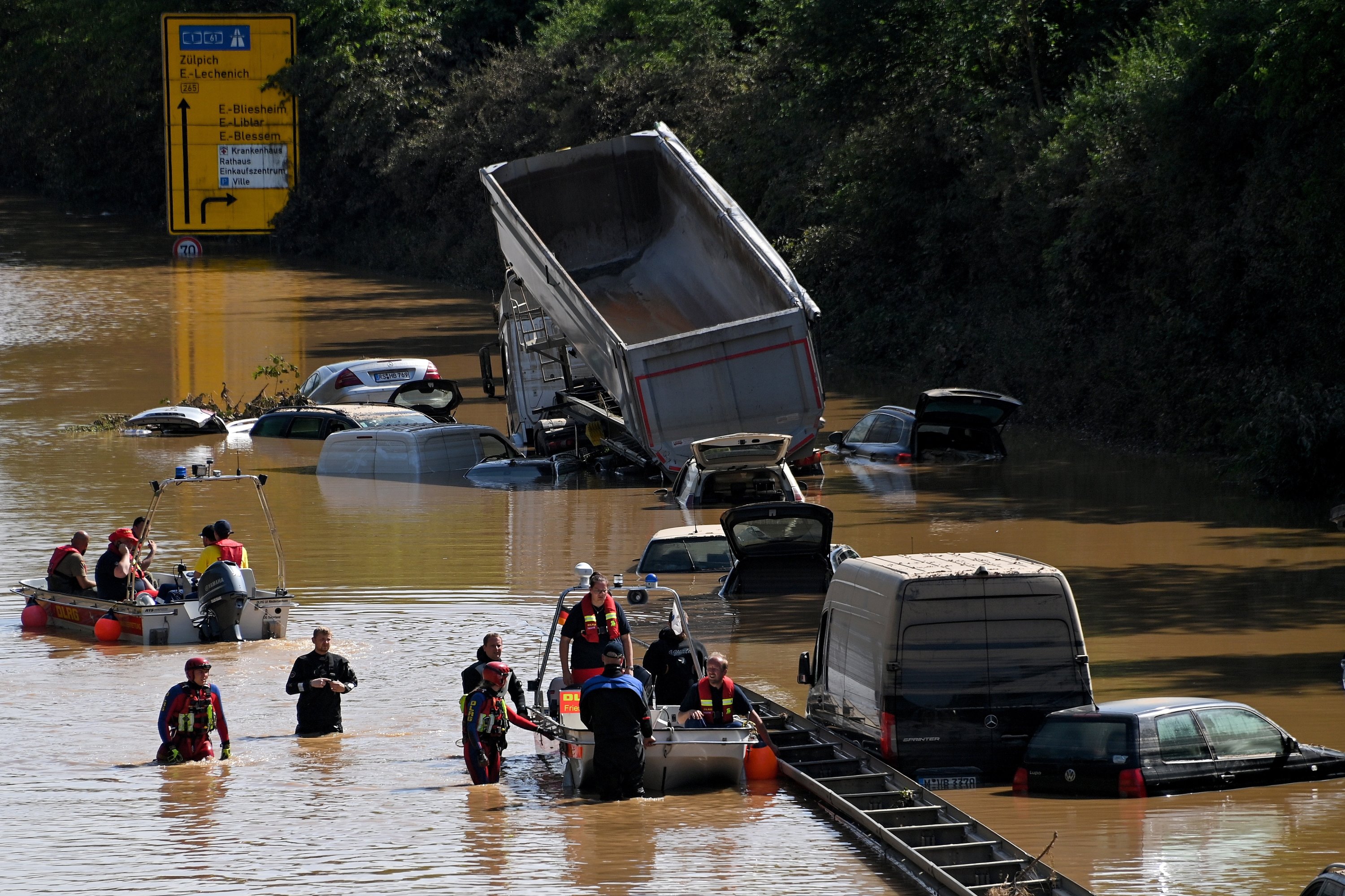Rescue services clear wrecked cars and trucks from the B265 federal highway in Erftstadt, Germany, July 17, 2021. (EPA Photo)