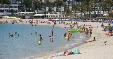People enjoy themselves at Magaluf beach in Mallorca as British tourists are expected to resume travels to the area starting from June 30th, Spain, June 29, 2021. (Reuters Photo)