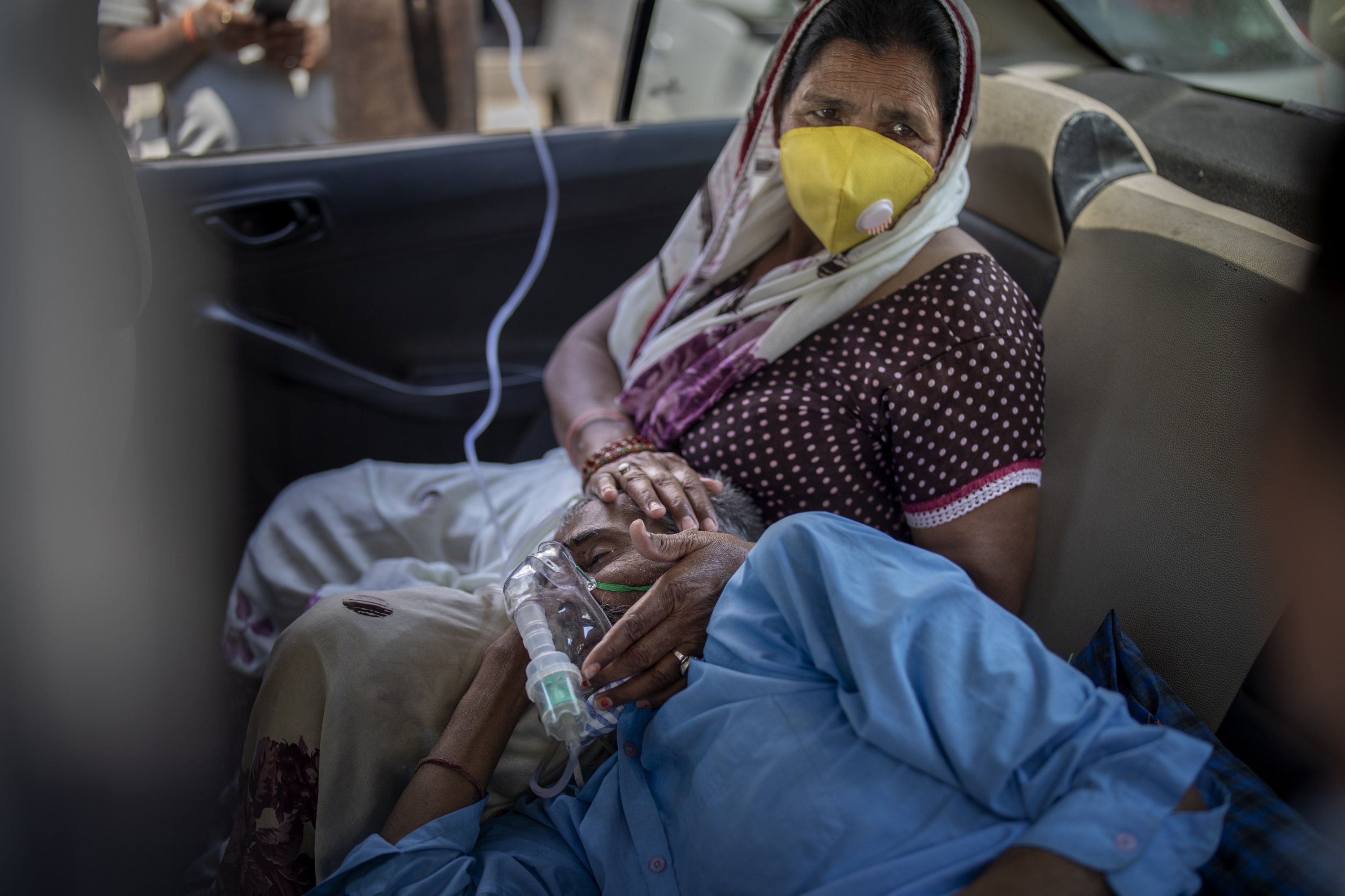 A patient breathes with the help of oxygen provided by a gurdwara, a Sikh place of worship, inside a car in New Delhi, India, April 24, 2021. (AP Photo)