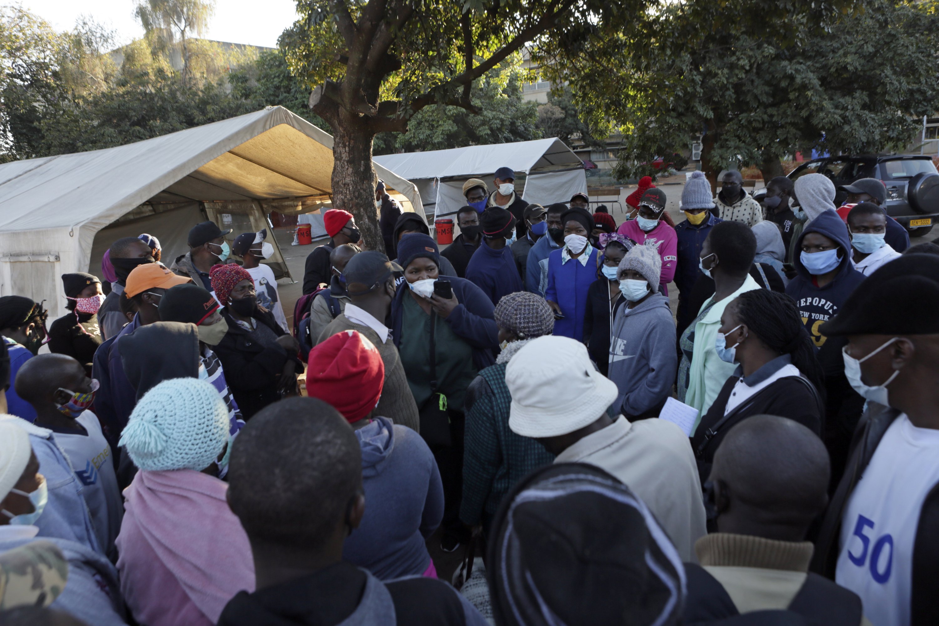 People try to figure out what to do after being turned away at a government hospital while seeking to be vaccinated against COVID-19 in Harare, Zimbabwe, July, 10, 2021.  (AP Photo)