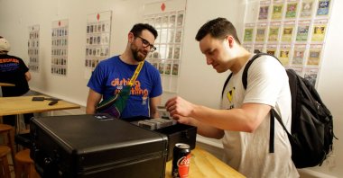 Traders exchange sports cards at Bleecker Trading in New York, U.S., July 06, 2021. (AFP Photo)