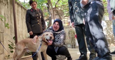Remziye Akdal cries as she pets Atmaca, in Kahramanmaraş, Turkey, July 18, 2021. (DHA PHOTO)