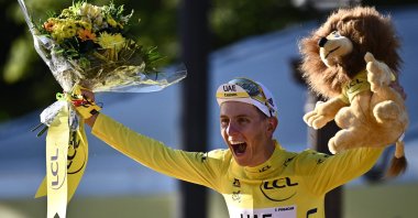Team UAE Emirates' Tadej Pogacar of Slovenia celebrates his overall leader yellow jersey on the podium at the end of the 21st and last stage of the 108th edition of the Tour de France, July 18, 2021. (AFP Photo)