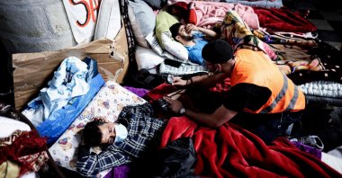 A paramedic volunteer treats a migrant on hunger strike as he occupies the Church of Saint-Jean-Baptiste au Beguinage in Brussels, Belgium, June 2, 2021. (AFP Photo)
