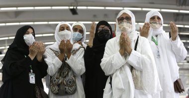 Muslim pilgrims pray during the symbolic stoning of the devil ritual during the hajj pilgrimage in Mina, near the holy city of Mecca, Saudi Arabia, July 20, 2021. (AP Photo)
