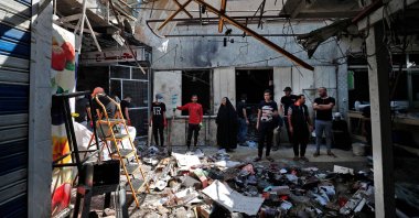 Iraqis inspect the site of the explosion a day earlier in a popular market in the Sadr City neighborhood, near capital Baghdad, Iraq, July 20, 2021. (AFP Photo)