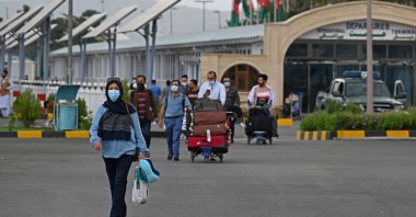 Passengers walk out from the arrivals of the Hamid Karzai International Airport in Kabul on July 16, 2021. (AFP Photo)