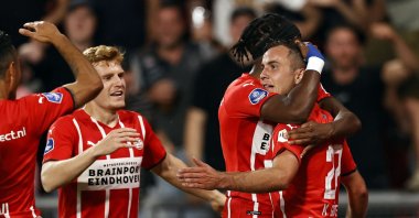 PSV's Israeli forward Eran Zahavi, PSV's Belgian forward Yorbe Vertessen, PSV's English forward Noni Madueke and PSV's German midfielder Mario Gotze celebrate the 3-1 goal during the Champions League qualifying football match between PSV Eindhoven and Galatasaray SK at the Phillips stadium in Eindhoven, on July 21, 2021. (AFP Photo)