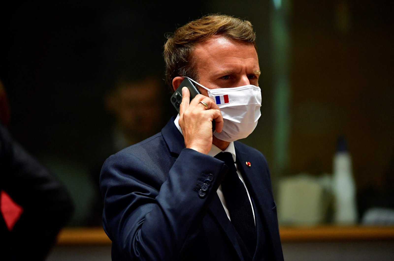 French President Emmanuel Macron speaks on the phone during an EU summit in Brussels, Belgium, July 20, 2021. (AFP Photo)