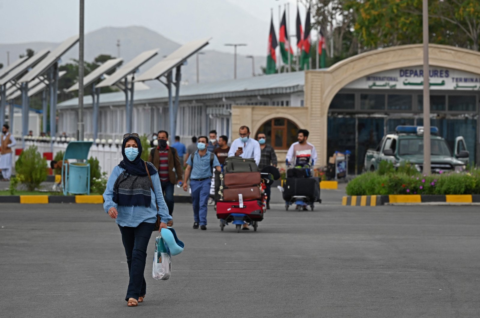 Passengers walk out from the arrivals of the Hamid Karzai International Airport in Kabul on July 16, 2021. (AFP Photo)