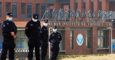 Security personnel keep watch outside Wuhan Institute of Virology during a visit by a World Health Organization (WHO) team tasked with investigating the origins of the COVID-19 disease, in Wuhan, Hubei province, China on Feb. 3, 2021.
