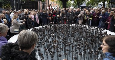 People look at the "Iron roses" memorial dedicated to 77 people who lost their lives to the 2011 terrorist attacks, in Oslo, Norway, Sept. 28, 2019. (AP Photo)