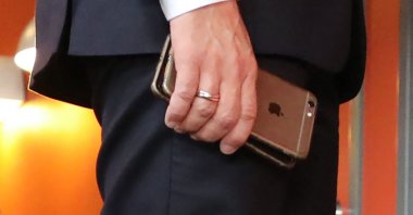 France's President Emmanuel Macron holds his mobile phones while talking with Slovakia's prime minister during the European Social Summit in Gothenburg, Sweden,  Nov. 17, 2017.  (AFP Photo)
