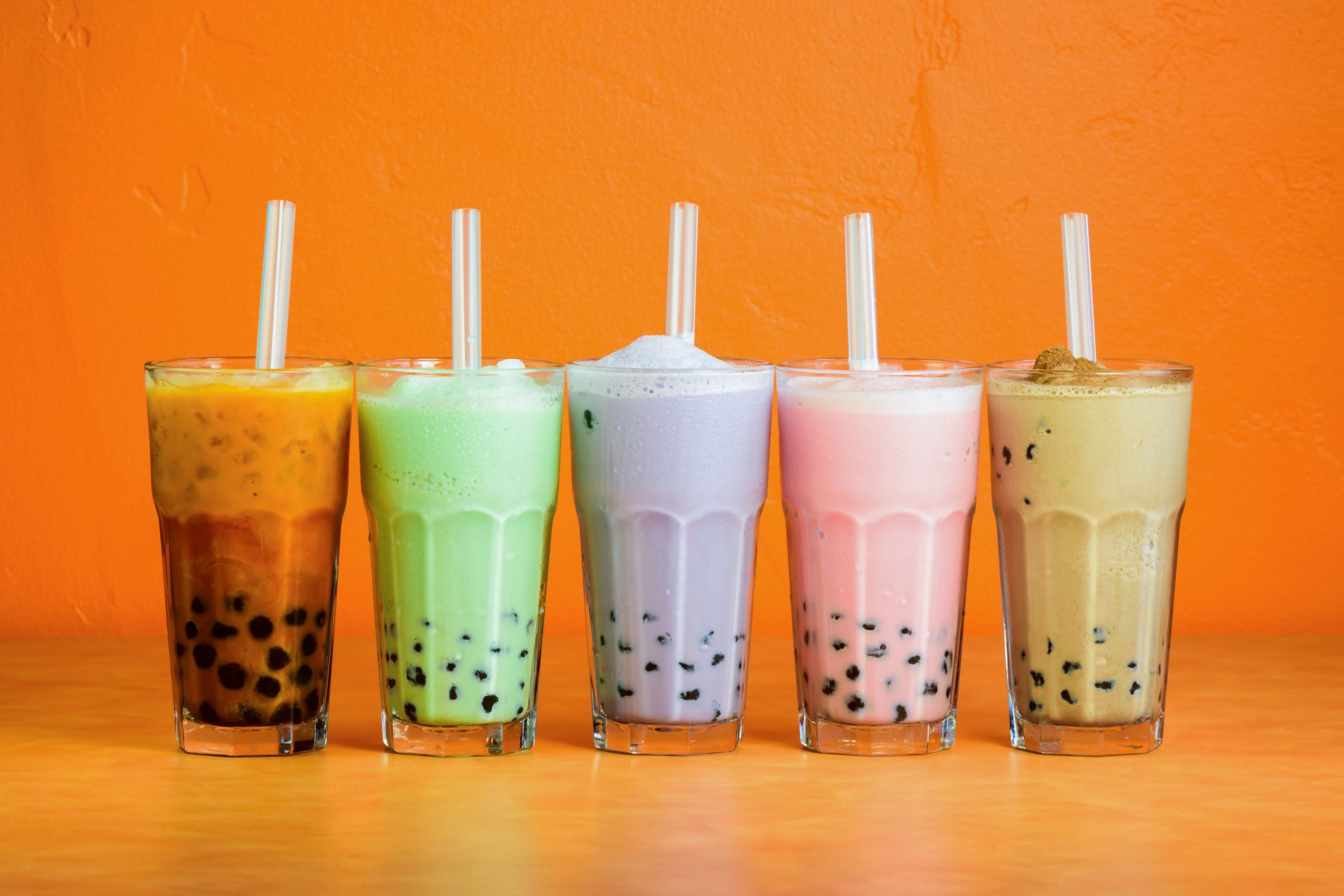 Different bubble teas in tall glasses lined up. (Shutterstock Photo)
