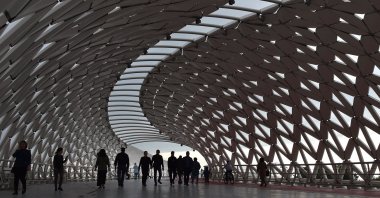 Pedestrians walk on a bridge over the Ishim River in Nur-Sultan, Kazakhstan, June 8, 2019. (AFP Photo)