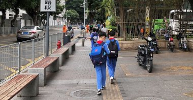 Children leave a school in the Shekou area of Shenzhen, Guangdong province, China, April 20, 2021. (Reuters Photo)