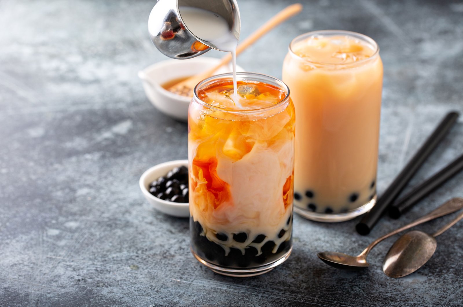 Pouring milk into the bubble tea and seeing it marble into perfection might be the most satisfying part of making your own bubble tea. (Shutterstock Photo)