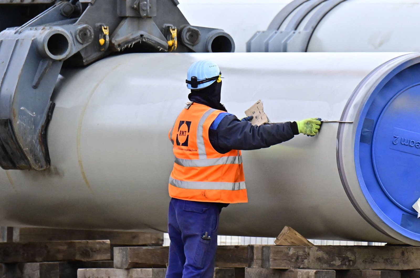 A worker moves a pipe at the construction site of the so-called Nord Stream 2 gas pipeline in Lubmin, northeastern Germany, on March 26, 2019. (AFP Photo)