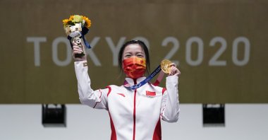 Yang Qian, of China, holds her gold medal after winning the women's 10-meter air rifle at the Asaka Shooting Range in the 2020 Summer Olympics, in Tokyo, Japan, July 24, 2021. (AP Photo)
