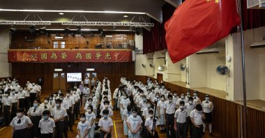 Students at the Hong Kong Federation of Education Workers Wong Cho Bau Secondary School take part in a weekly flag raising ceremony in Hong Kong, China, June 7, 2021. (EPA Photo)