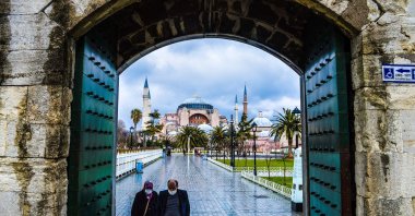 People walk towards the Blue Mosque as Hagia Sophia Grand Mosque is seen in the background in Istanbul, Turkey, March 2, 2021. (Getty Images)