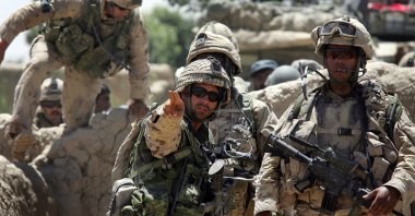 Canadian forces, including Sgt. Dave Limon (C) and Capt. Hugh Atwell (R), prepare to move through a village while conducting a search operation in the Panjwai district about 30 kilometers southwest of Kandahar, Afghanistan, June 13, 2006. (Getty Images)