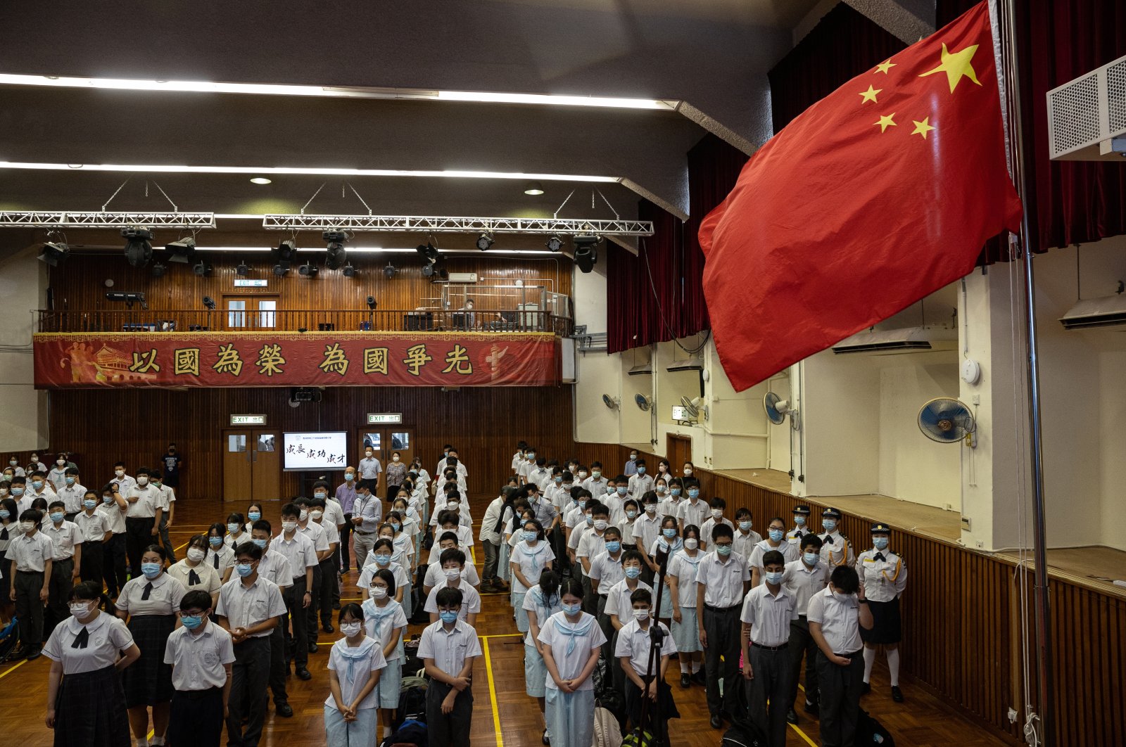 Students at the Hong Kong Federation of Education Workers Wong Cho Bau Secondary School take part in a weekly flag raising ceremony in Hong Kong, China, June 7, 2021. (EPA Photo)