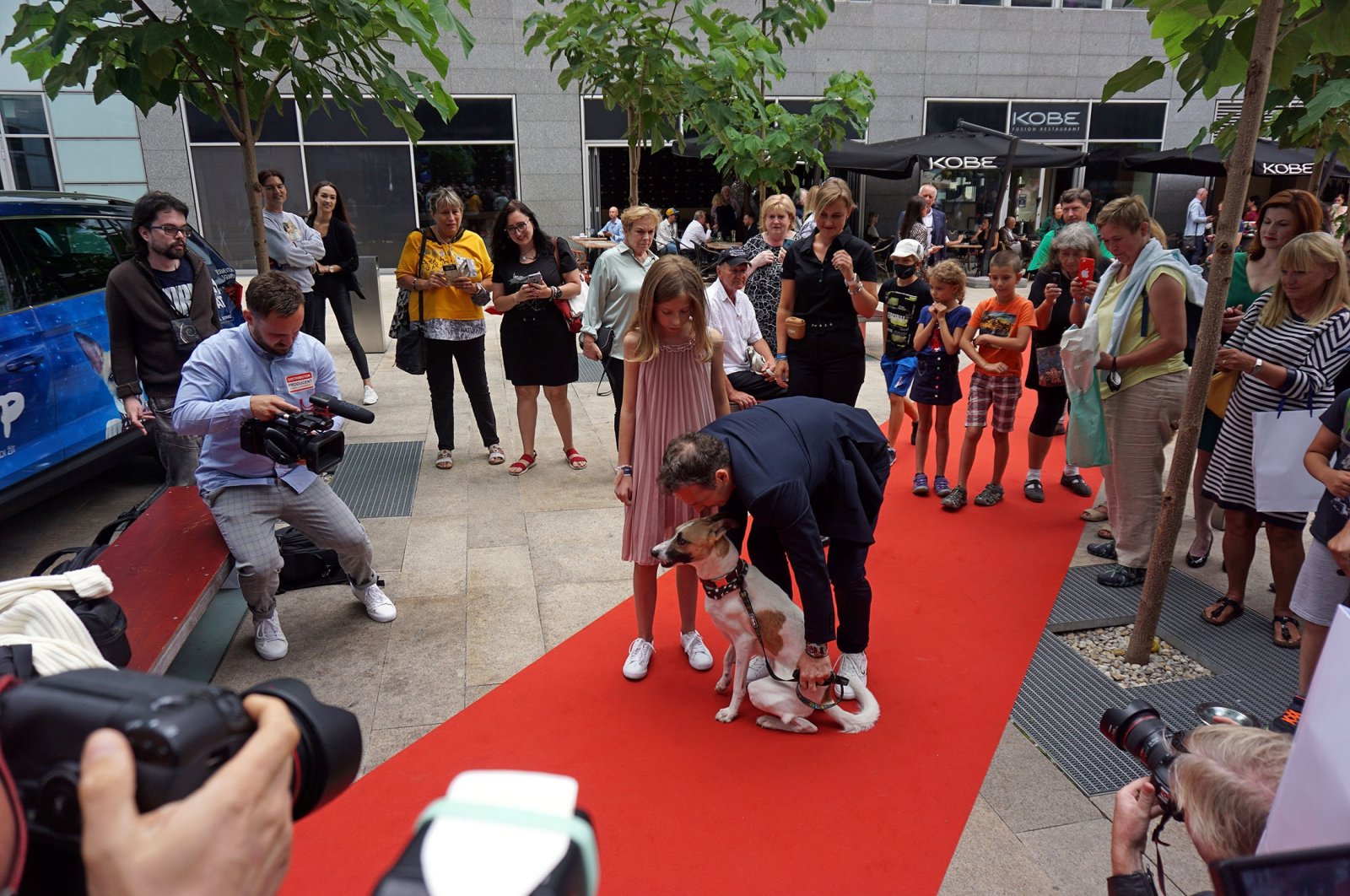 Writer Filip Rozek poses with his daughter and Gump the dog on the red carpet before the "Gump" premiere in Prague, Czech Republic, July 21, 2021. (Reuters Photo)