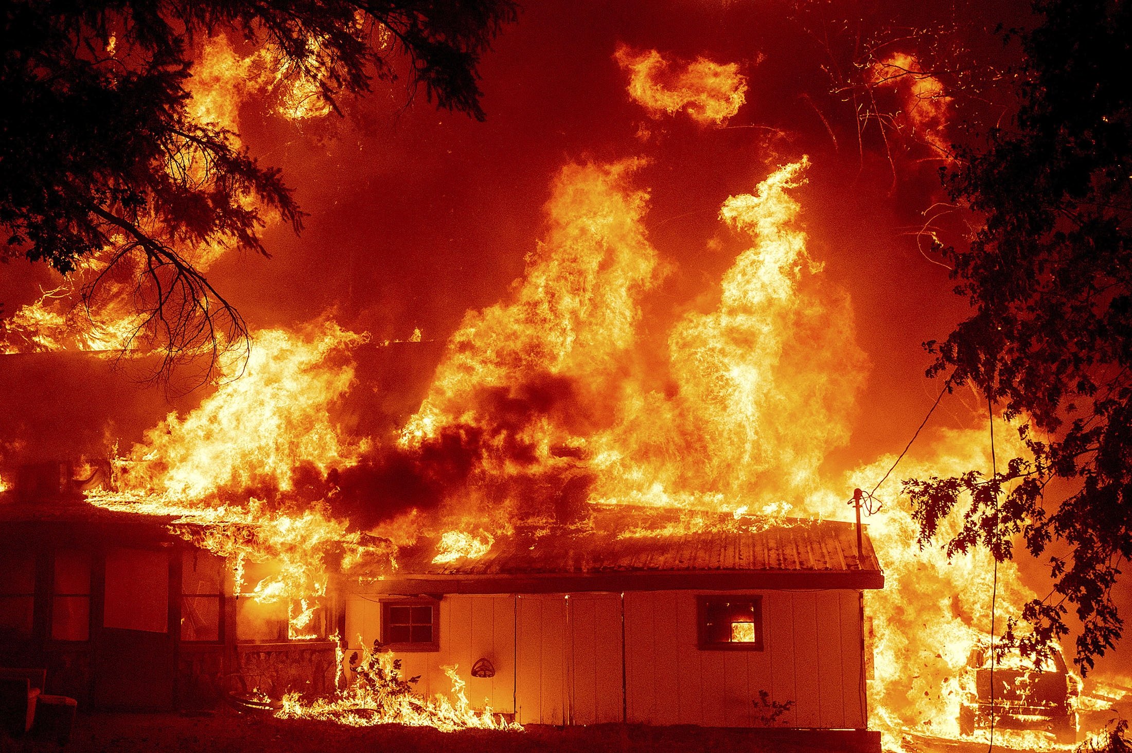 Flames consume a home as the Dixie Fire tears through the Indian Falls community in Plumas County, California, U.S., July 24, 2021. (AP Photo)