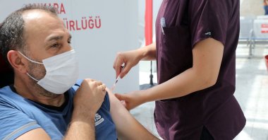 A man receives a dose of a COVID-19 vaccine at a vaccination center, set up at Ankara High-Speed Train Station, Ankara, Turkey, on June 28, 2021. (AFP)