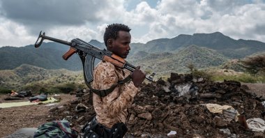 A member of the Afar Special Forces stands in front of the debris of a house in the outskirts of the village of Bisober, Tigray Region, Dec. 9, 2020. (AFP Photo)
