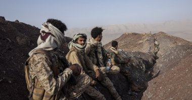 Yemeni fighters backed by the Saudi-led coalition stand at a distance from the front line after clashes with Houthi rebels on the Kassara front line near Marib, Yemen, June 20, 2021. (AP Photo)