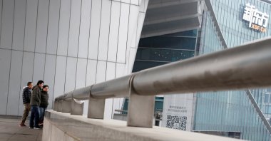 People stand outside the headquarters of the New Oriental Education & Technology Group in Beijing, China, Nov. 25, 2016. (Reuters Photo)