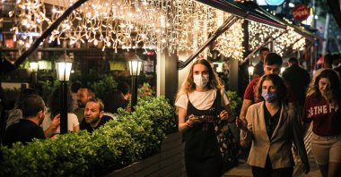 People eat at an open restaurant after midnight in the capital Ankara, Turkey, July 3, 2021. (Reuters Photo)
