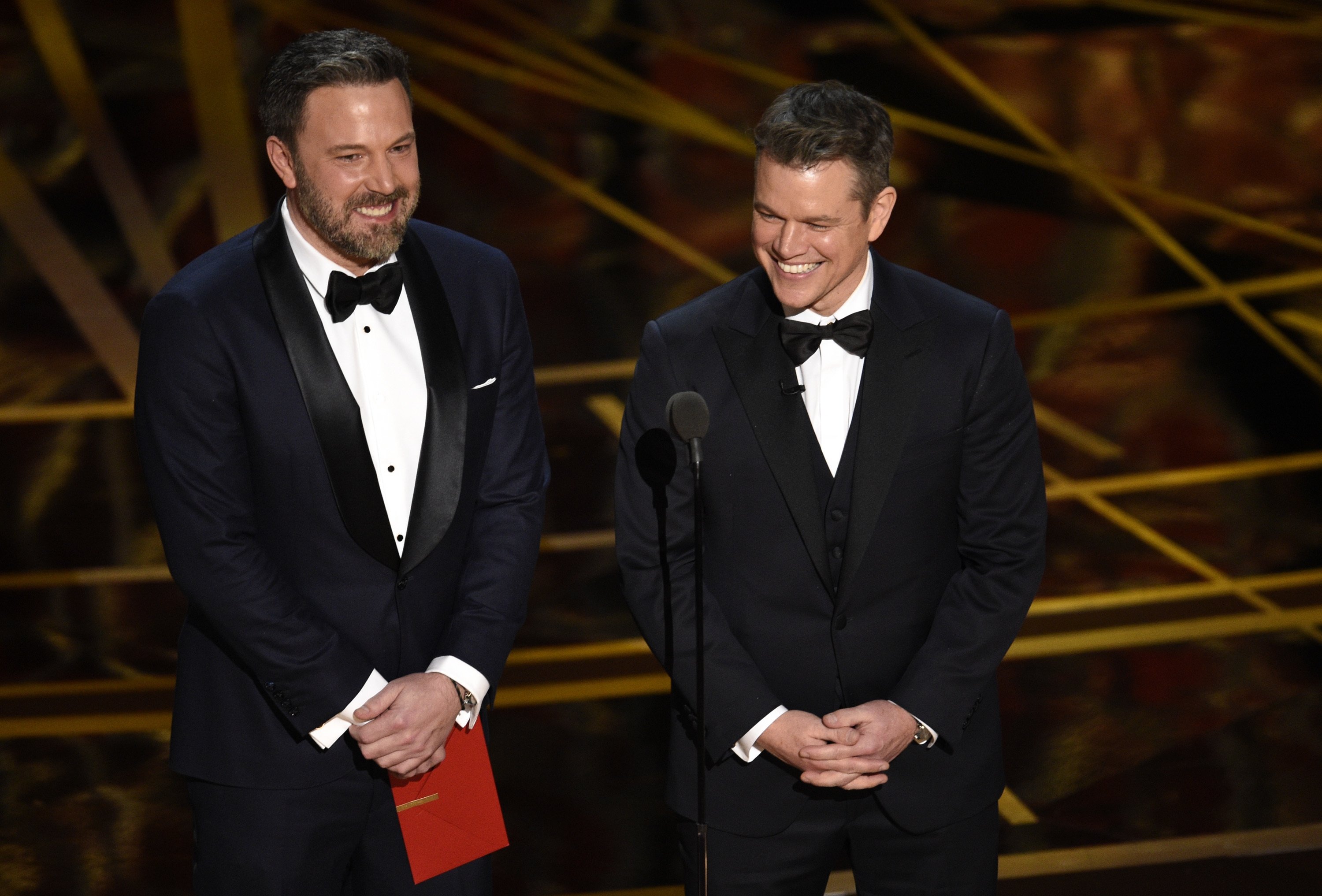 Ben Affleck (L) and Matt Damon present the award for best original screenplay at the Oscars at the Dolby Theatre in Los Angeles, California, U.S., Feb. 26, 2017. (AP Photo)