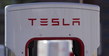The company logo is shown at the top of a supercharger for Tesla automobiles near shops Feb. 25, 2021 in Boulder, Colo. (AP Photo)
