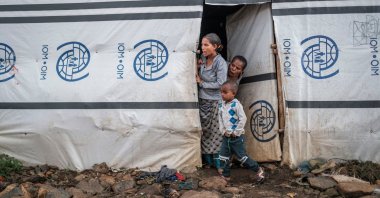 Internally displaced people stand at the door of a shelter at a camp in Azezo, Ethiopia, July 12, 2021. (AFP Photo)