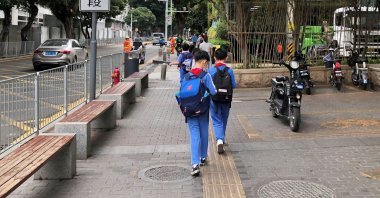Children leave a school in the Shekou area of Shenzhen, Guangdong province, China, April 20, 2021. (Reuters Photo)