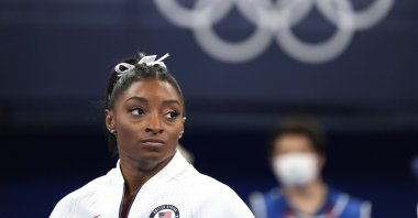 U.S.'s Simone Biles watches gymnasts perform after she exited the team final with an apparent injury, at the 2020 Summer Olympics, Tokyo, Japan, July 27, 2021. (AP Photo)