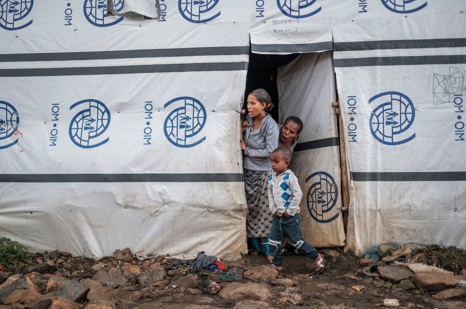 Internally displaced people stand at the door of a shelter at a camp in Azezo, Ethiopia, July 12, 2021. (AFP Photo)