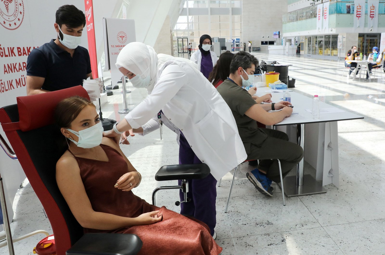 A woman receives a dose of a COVID-19 vaccine at a vaccination center set up at the Ankara High-Speed Train Station in Ankara, Turkey, June 28, 2021. (AFP Photo)