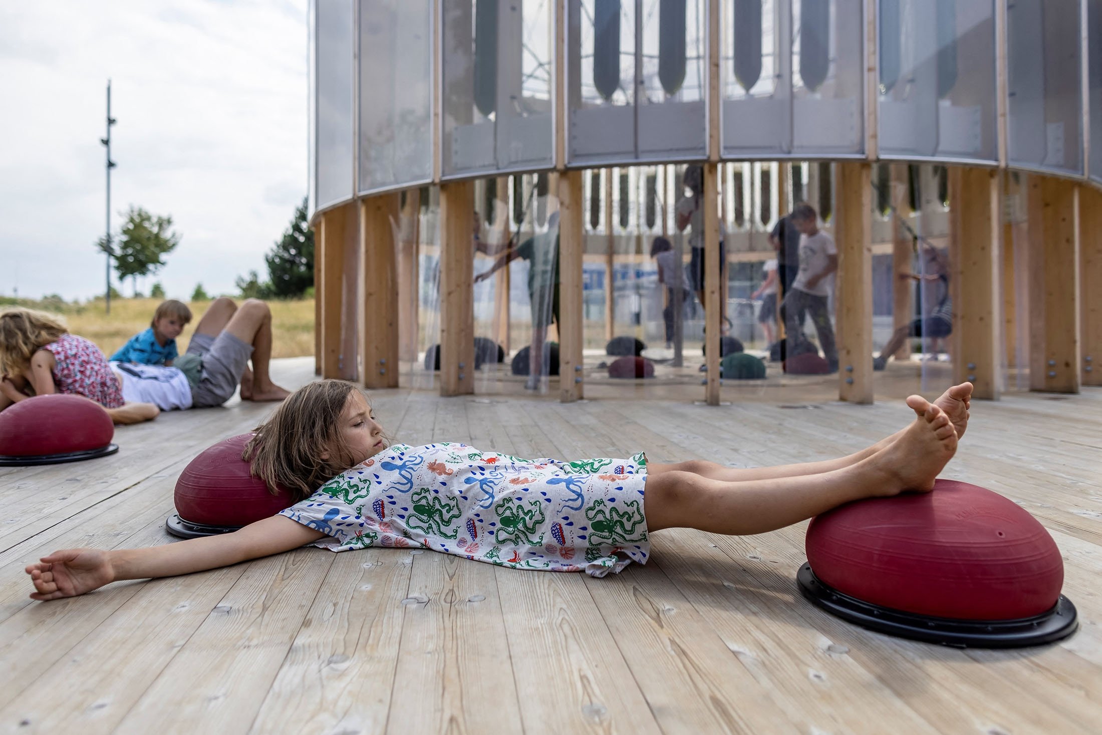 Nine-year-old Anielka rests after playing in an AirBubble, an innovative playground providing clean air thanks to algae that absorbs pollutants and CO2, in Warsaw, Poland, July 26, 2021. (AFP Photo)