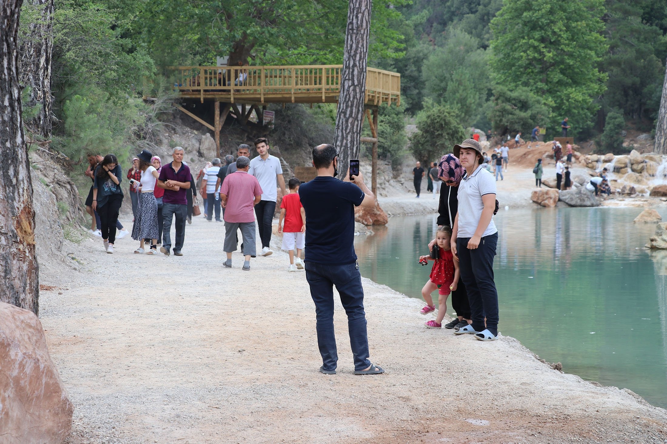 People walk around and pose for photos around a pond at the Acıpayam Canyon, Denizli, Turkey, July 25, 2021. (AA Photo)