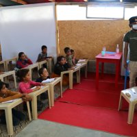 Ahmed Muhemid teaches his students inside the classroom, in Adana, southern Turkey, July 27, 2021. (IHA PHOTO)