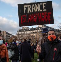 A protestor holds a placard that reads 'France Islamophobe' during a demonstration against the French government's global security bill and restrictions that target Muslim communities, Paris, France, Nov. 21, 2020. (Getty Images)